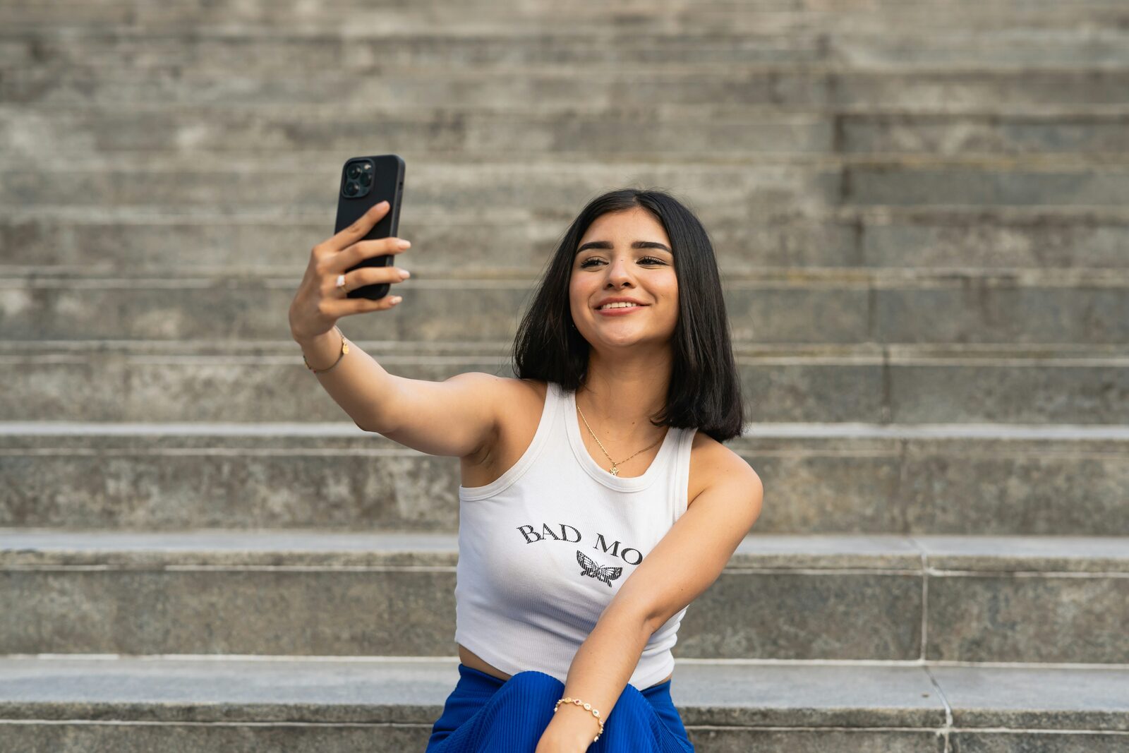 TikTok creator filming vertical content with phone and ring light